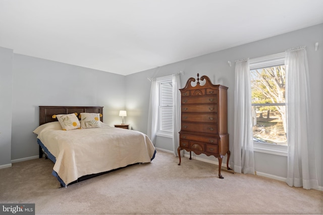 carpeted bedroom featuring baseboards