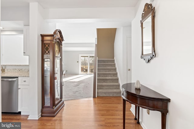 corridor with wood finished floors and stairs