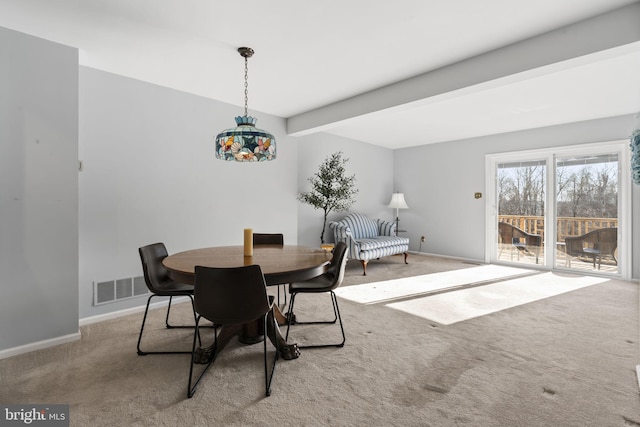 dining room featuring visible vents, carpet floors, baseboards, and beam ceiling