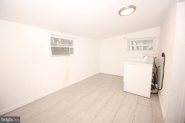 laundry area featuring baseboards, washer / clothes dryer, and laundry area