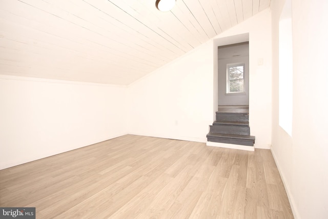 interior space featuring wood ceiling, lofted ceiling, stairway, and light wood-style floors