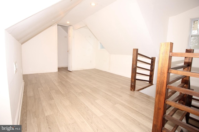 additional living space with vaulted ceiling, recessed lighting, and wood finished floors