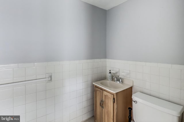 2011 Wardman Rd, Hyattsville, MD 20782 - bathroom featuring vanity, tile walls, toilet, and wainscoting