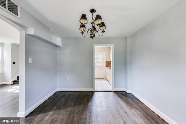 2011 Wardman Rd, Hyattsville, MD 20782 - unfurnished dining area featuring visible vents, a notable chandelier, wood finished floors, stairway, and baseboards