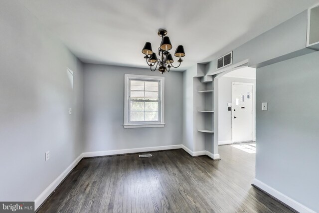 2011 Wardman Rd, Hyattsville, MD 20782 - unfurnished dining area featuring built in features, wood finished floors, visible vents, baseboards, and a notable chandelier