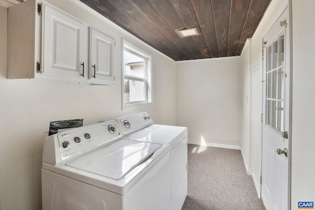 washroom with washing machine and dryer, wood ceiling, and baseboards