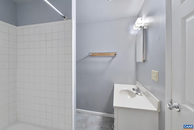 bathroom featuring tile patterned flooring, tub / shower combination, vanity, and baseboards