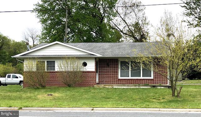 single story home with brick siding and a front lawn