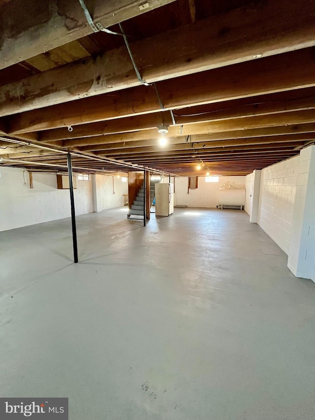 unfinished basement featuring stairs