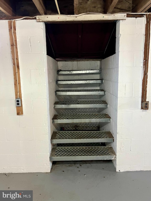 stairway with concrete flooring