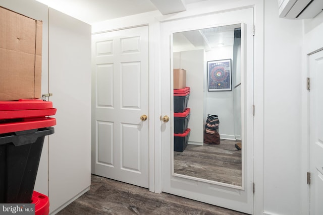 interior space featuring an AC wall unit and wood finished floors