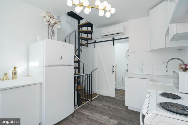 kitchen featuring tasteful backsplash, dark wood-style floors, a wall unit AC, white appliances, and white cabinets