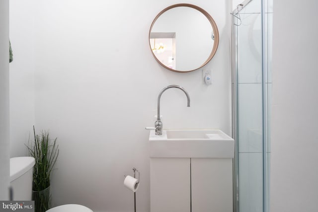 bathroom featuring toilet and vanity