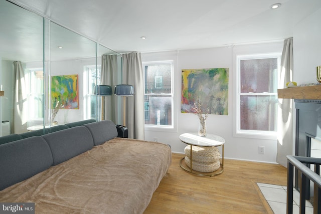 bedroom with recessed lighting and wood finished floors