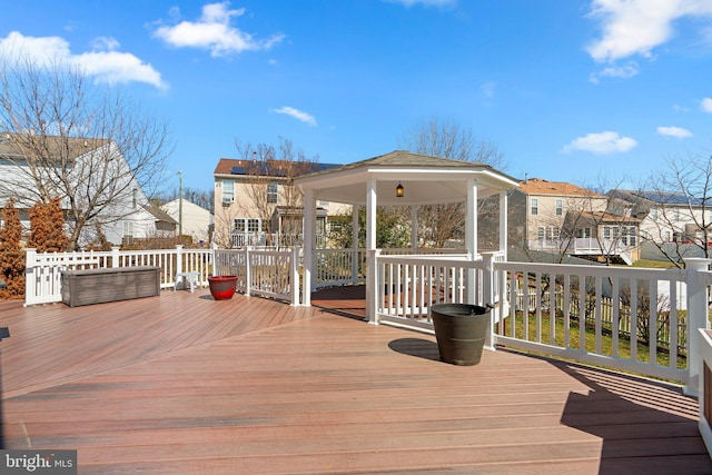 wooden terrace with a gazebo and a residential view