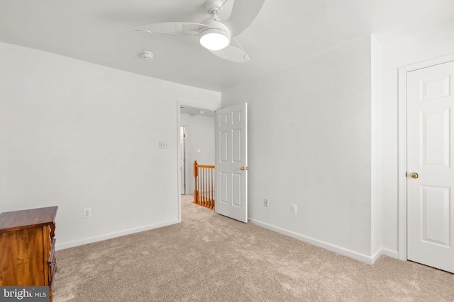 unfurnished bedroom with ceiling fan, baseboards, and carpet