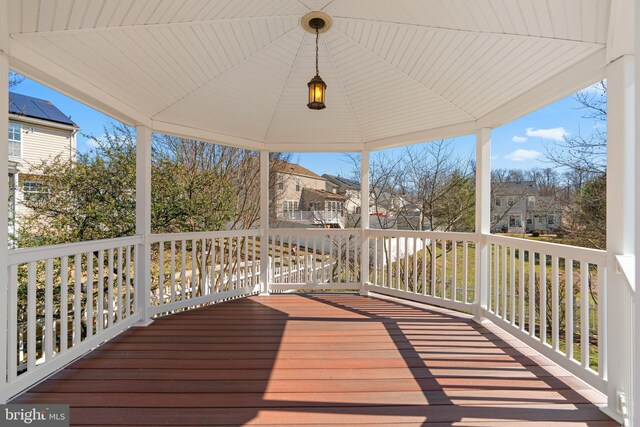 wooden deck with a gazebo and a residential view