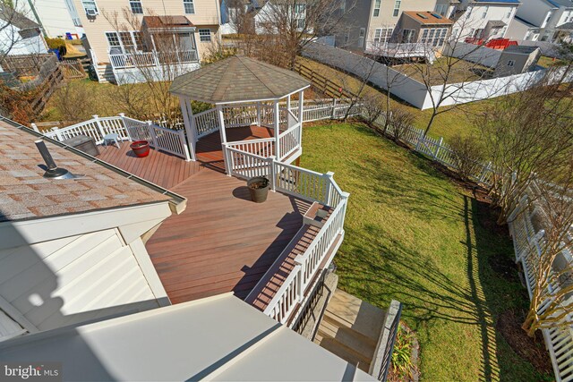 exterior space featuring a deck, a gazebo, and fence