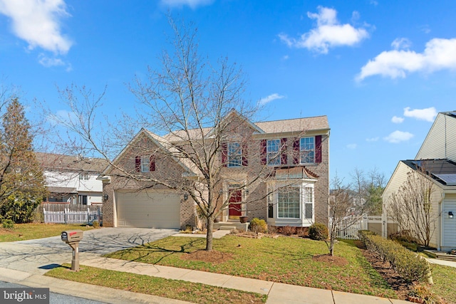 traditional-style house with brick siding, driveway, a front yard, and fence