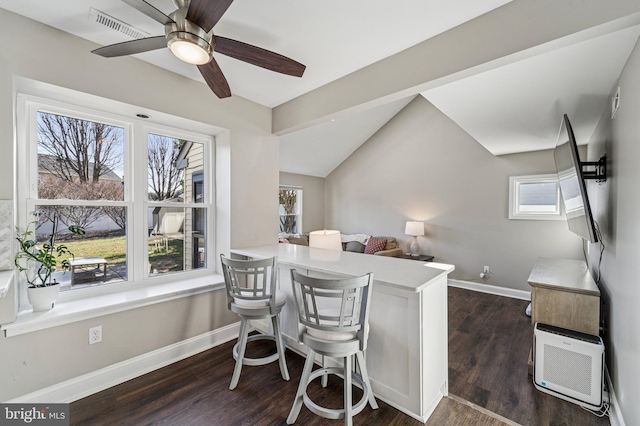 dining space with visible vents, baseboards, and dark wood-style flooring