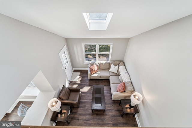 living area featuring a skylight, wood finished floors, and baseboards