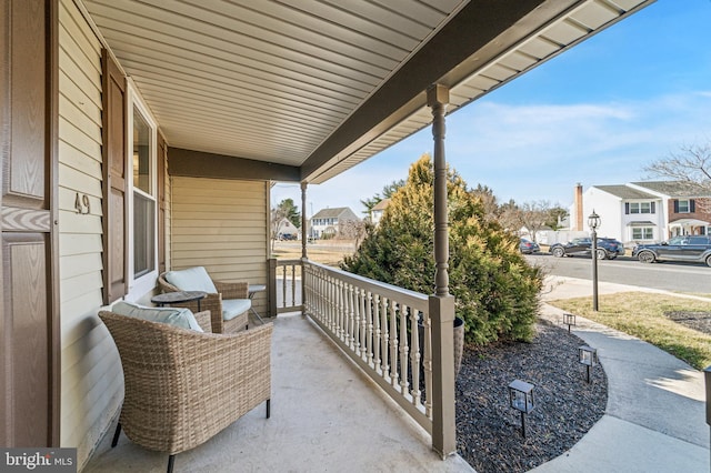 view of patio / terrace with a residential view and a porch