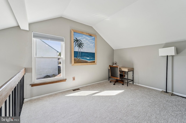 carpeted office with vaulted ceiling, baseboards, and visible vents