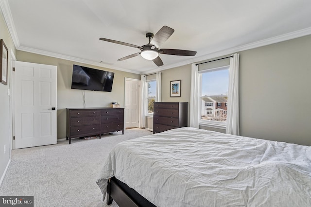 bedroom featuring carpet flooring, baseboards, crown molding, and a ceiling fan