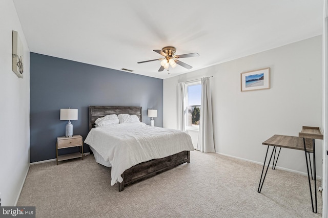 carpeted bedroom featuring visible vents, a ceiling fan, and baseboards