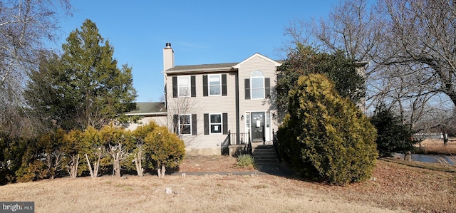 view of front facade featuring a chimney