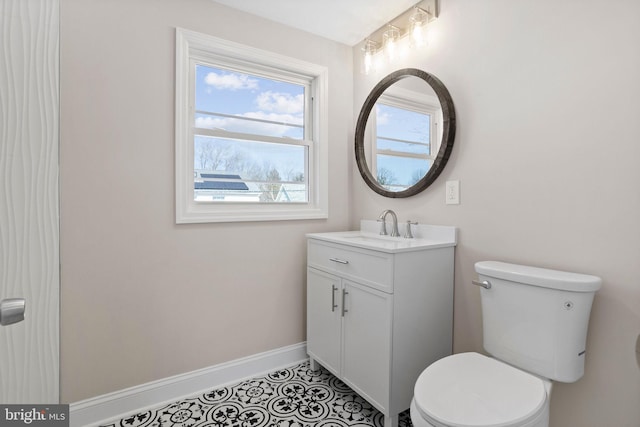 bathroom featuring vanity, tile patterned floors, toilet, and baseboards