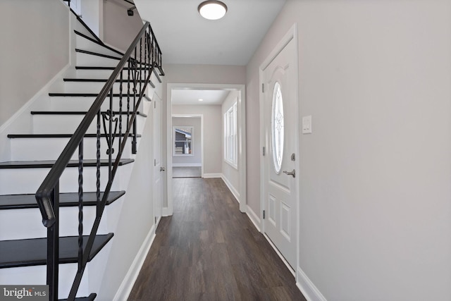 foyer entrance featuring stairway, wood finished floors, and baseboards