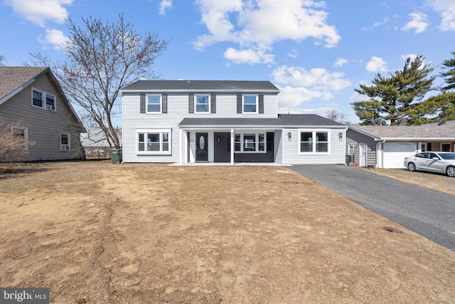 view of front of home with aphalt driveway and a porch