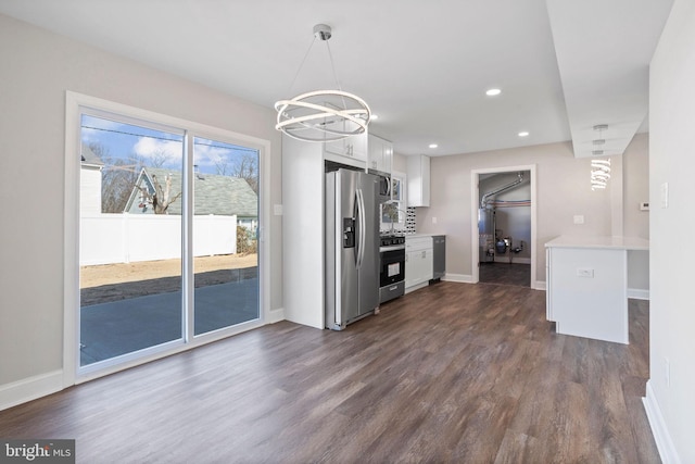 kitchen with dark wood-type flooring, recessed lighting, stainless steel appliances, white cabinets, and light countertops