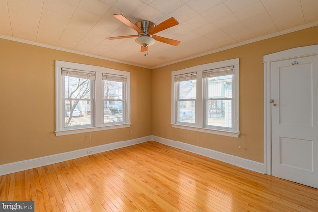 unfurnished room featuring light wood-type flooring, baseboards, and ornamental molding