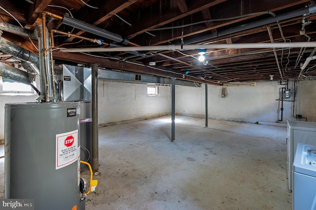 below grade area featuring gas water heater and washer / dryer