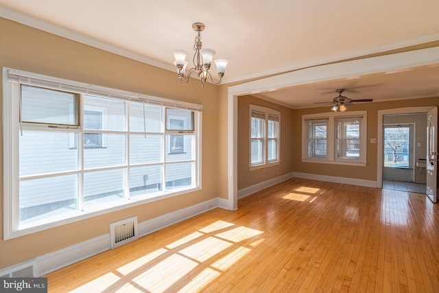 unfurnished dining area with light wood finished floors, visible vents, crown molding, and baseboards