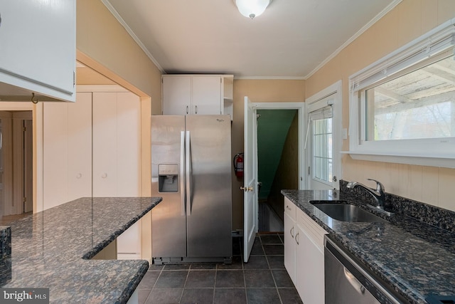 kitchen featuring a sink, stainless steel appliances, ornamental molding, and white cabinetry