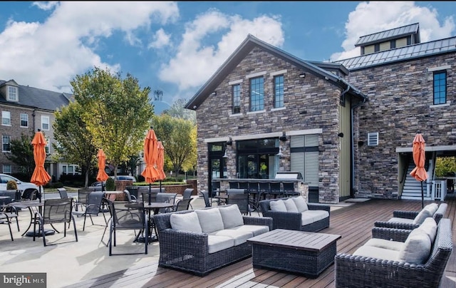 wooden deck featuring an outdoor living space and outdoor dry bar