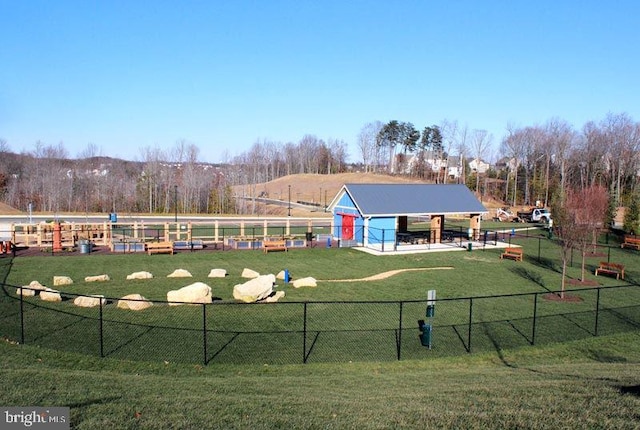 view of community featuring fence and a lawn