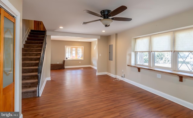 interior space with wood finished floors, baseboards, a ceiling fan, recessed lighting, and stairs