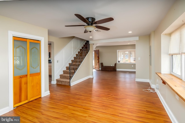 entrance foyer with stairway, a ceiling fan, baseboards, recessed lighting, and light wood-type flooring