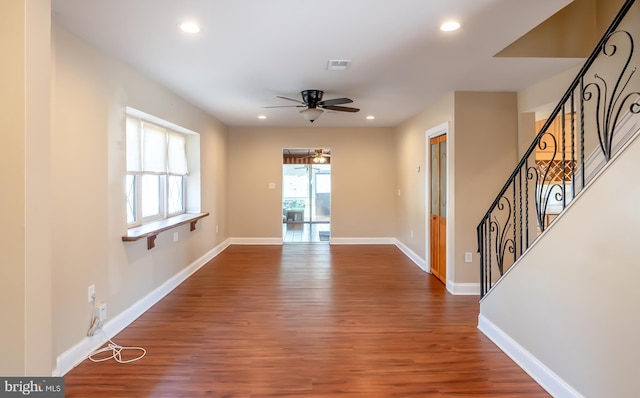 unfurnished living room featuring stairway, wood finished floors, baseboards, recessed lighting, and ceiling fan