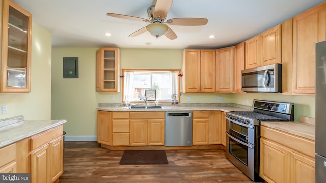 kitchen featuring a sink, appliances with stainless steel finishes, light brown cabinets, and light countertops