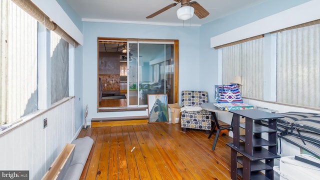 interior space with wood-type flooring and ceiling fan