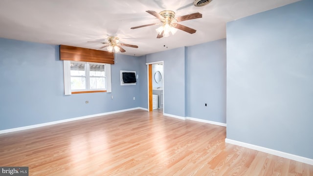 empty room featuring visible vents, baseboards, light wood-style floors, and a ceiling fan