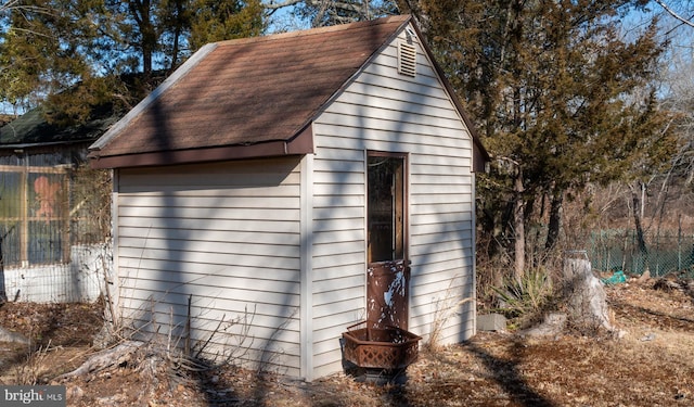 view of outbuilding with an outbuilding and fence