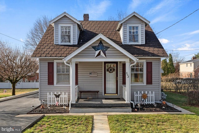 802 E 11th Ave, York, PA 17402 - view of front of home featuring covered porch, roof with shingles, and a chimney