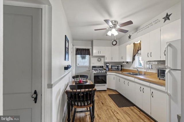 802 E 11th Ave, York, PA 17402 - kitchen featuring white appliances, ceiling fan, a sink, white cabinets, and light wood-style floors