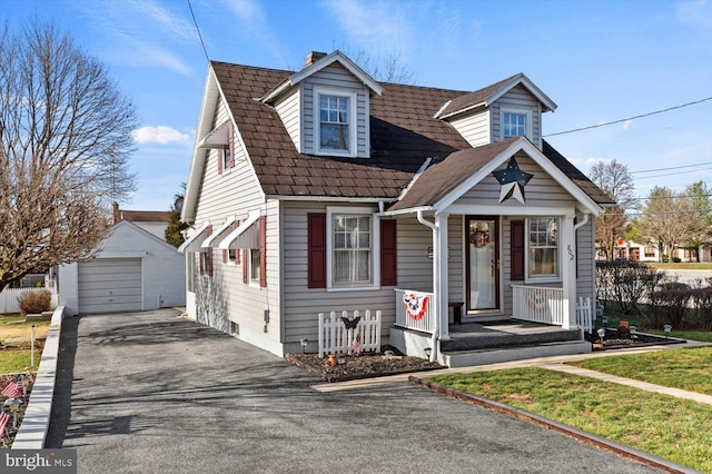 802 E 11th Ave, York, PA 17402 - view of front of home with an outbuilding, driveway, a detached garage, covered porch, and a chimney